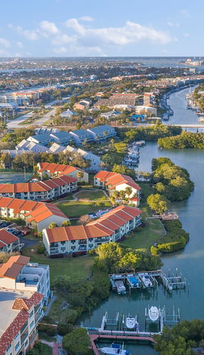 Florida waterfront homes with boat docks on a calm canal at dusk